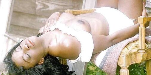 Dark doll posing her nude assets outdoors