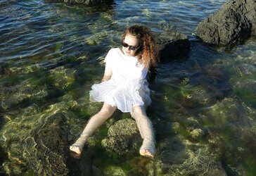 Super-Cute wooly fledgling dark haired posing dressed in the river