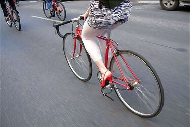 Honeys railing bicyles in high high-heeled slippers