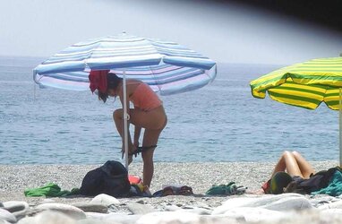 Beach disrobing, disrobing or getting bare