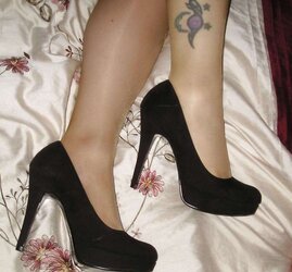 Suntan pantyhose and ebony high-heeled shoes