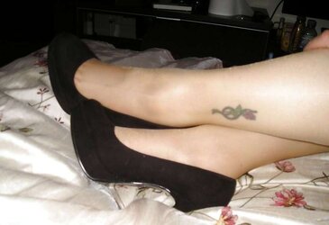 Suntan pantyhose and ebony high-heeled shoes
