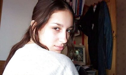 Fledgling brown-haired posing in her bedroom