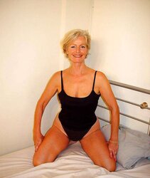 Justine a mature platinum-blonde posing on a sofa