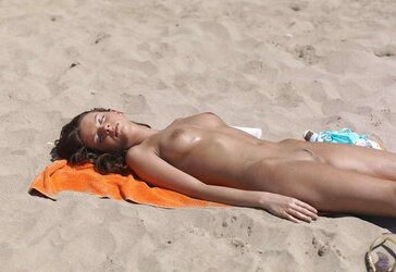 Luxurious youthful woman bare on the beach