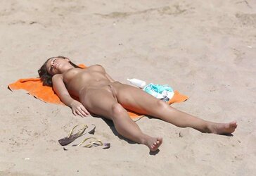 Luxurious youthful woman bare on the beach