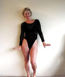 Justine a mature blondie posing in a ebony bondage suit