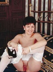 Mature lady plays with her slit on her sofa