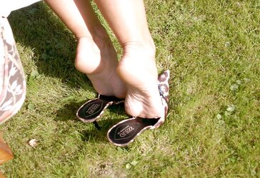 Mature dark-haired in leopard mules outside