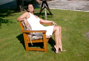 Mature dark-haired in leopard mules outside