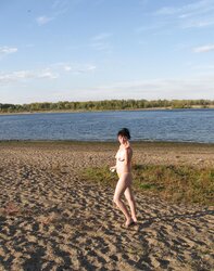 Lili bare on a public beach