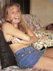 Laughing blond posing her nice assets