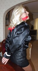 Light-Haired roped up wearing leather miniskirt and high high-heeled slippers