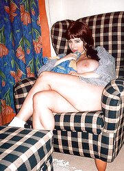 Huge-Boobed nice black-haired posing on a tabouret