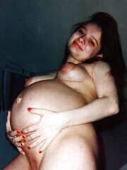 Pregnant black-haired posing her nice tummy